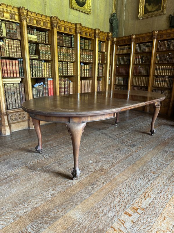 A GEORGE III STYLE MAHOGANY EXTENDING DINING TABLE