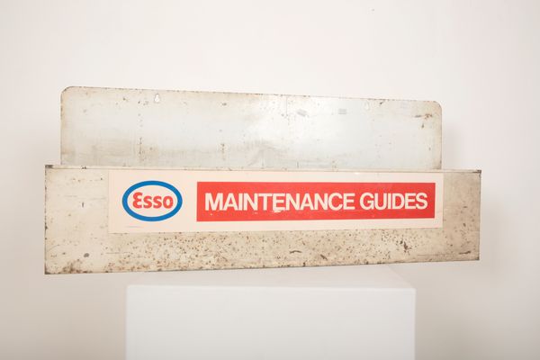 AN 'ESSO MAINTENANCE GUIDES' WALL HANGING OPEN SHELF