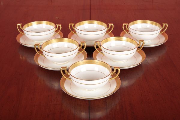 A SET OF SIX MINTON TWO-HANDLED CUPS AND SAUCERS