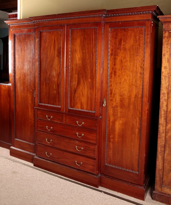 A GEORGE III STYLE MAHOGANY TRIPLE WARDROBE