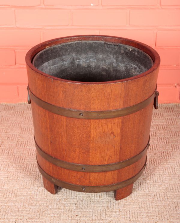 AN EDWARDIAN TEAK AND BRASS BOUND PLANTER STAMPED LISTER