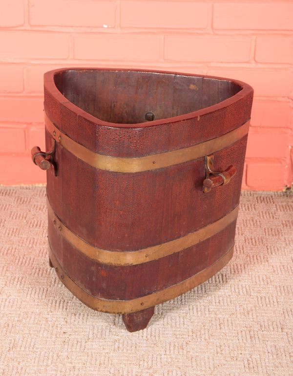 AN EDWARDIAN TEAK AND BRASS BOUND TRIFORM PLANTER BY CHAMPION & CO, LONDON