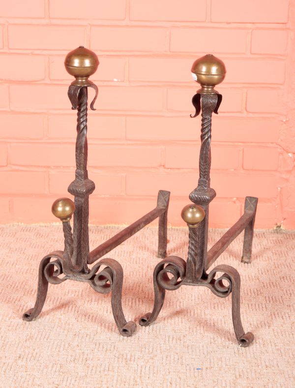 A PAIR OF ARTS AND CRAFTS STYLE WROUGHT IRON FIRE DOGS