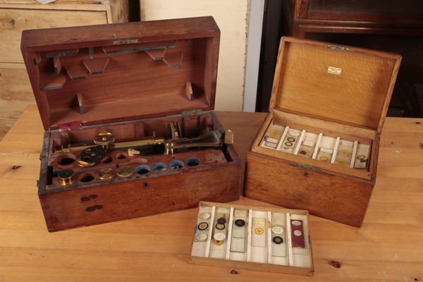 A 19TH CENTURY LACQUERED AND EBONISED BRASS MONOCULAR MICROSCOPE