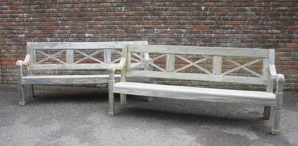 A PAIR OF WEATHERED TEAK GARDEN BENCHES