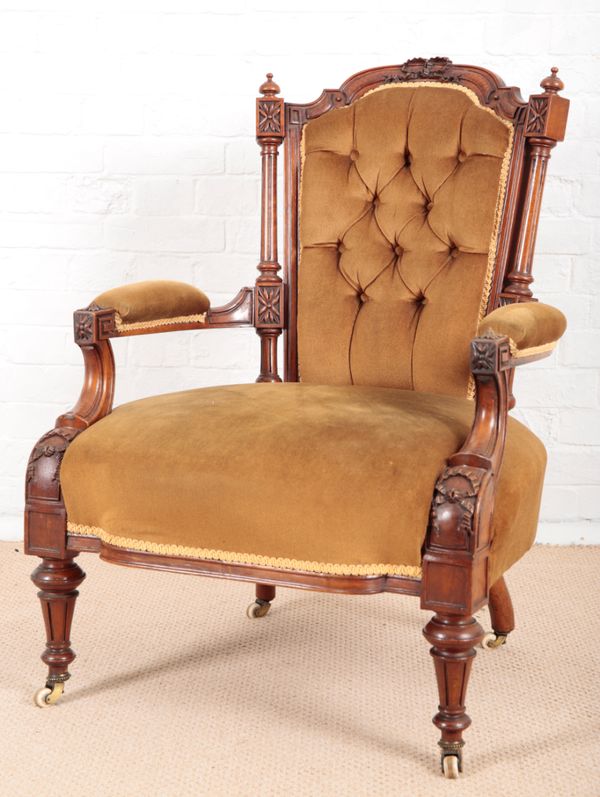 A VICTORIAN WALNUT OPEN ARMCHAIR