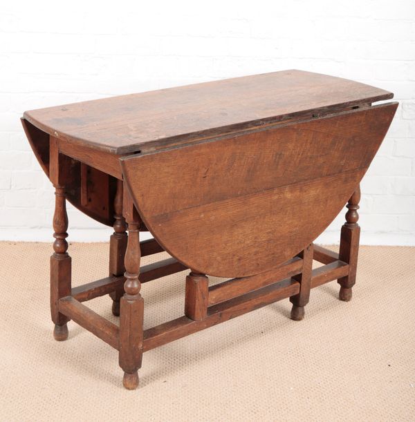 AN OAK OVAL GATELEG TABLE