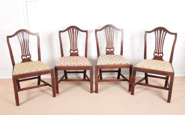 A SET OF FOUR GEORGE III MAHOGANY DINING CHAIRS OF HEPPLEWHITE DESIGN