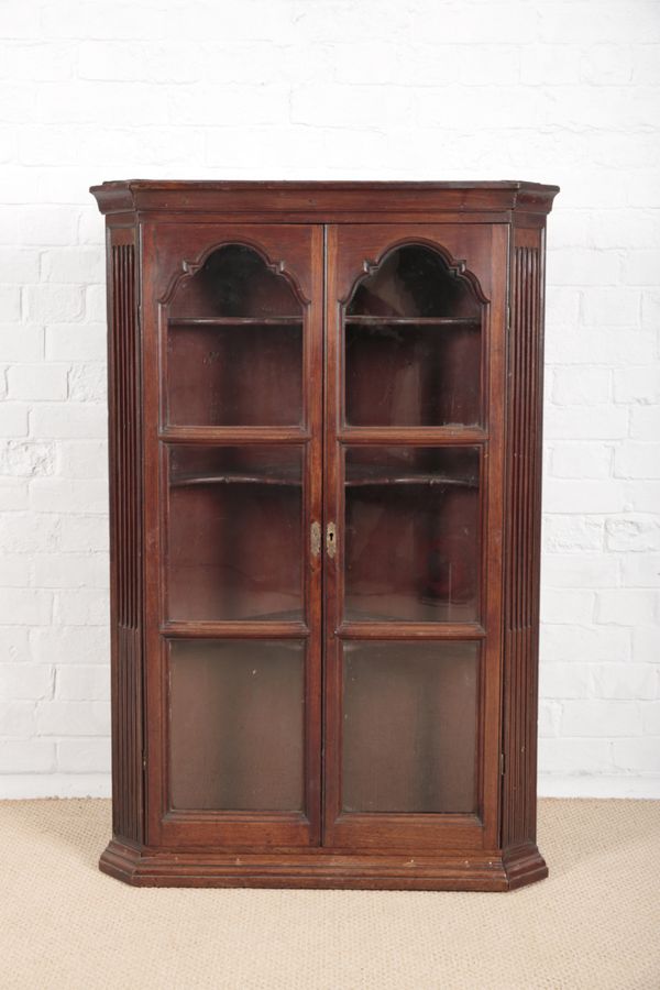 A GEORGE III MAHOGANY CORNER CUPBOARD