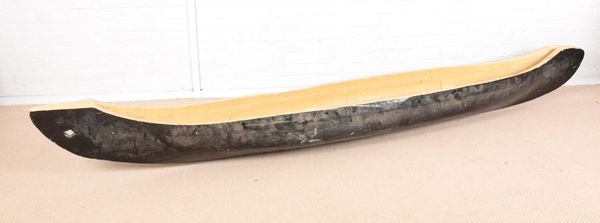 A NATIVE AMERICAN HARDWOOD PAINTED SINGLE CANOE