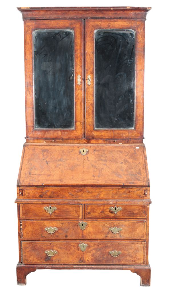 AN EARLY GEORGE II WALNUT BUREAU BOOKCASE