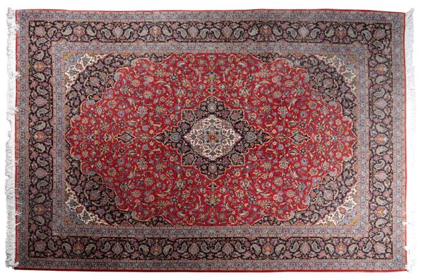 A SIGNED KASHAN CARPET