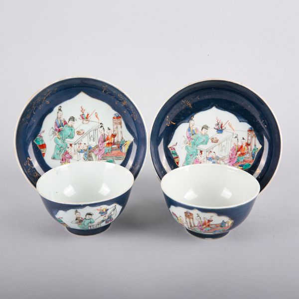 A PAIR OF CHINESE FAMILLE ROSE CUPS AND SAUCERS