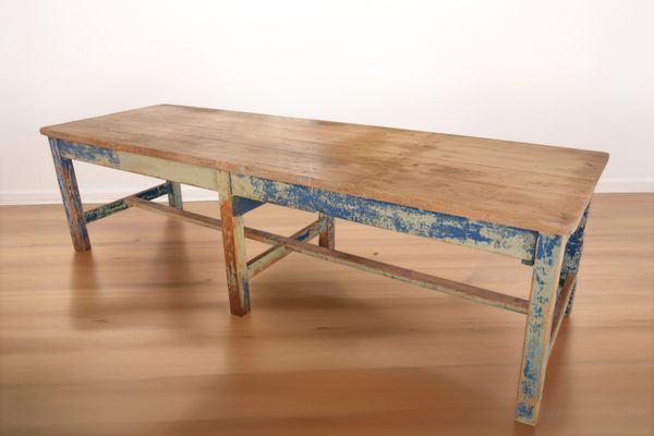 A LARGE PAINTED WOOD INDUSTRIAL WORKBENCH