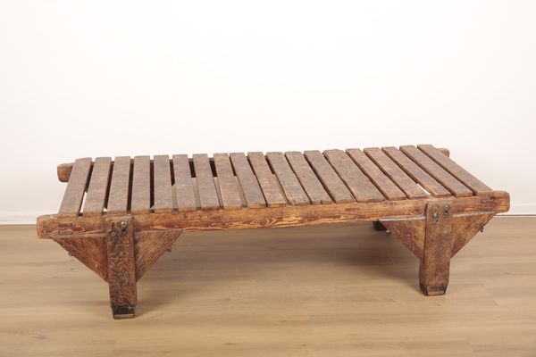 A LOW INDUSTRIAL PINE WORKBENCH CONVERTED TO A COFFEE TABLE