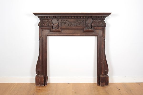 A VICTORIAN CARVED AND STAINED PINE FIRE SURROUND