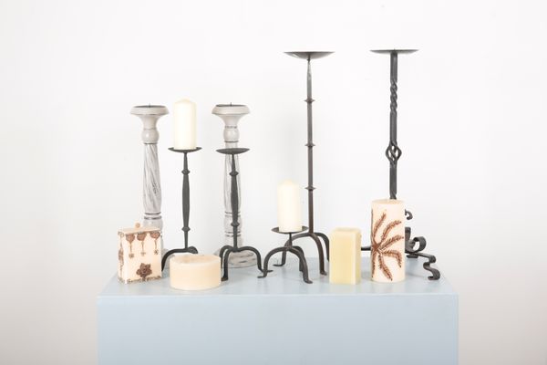 A COLLECTION OF PRICKET CANDLESTICKS AND ASSORTED CANDLES