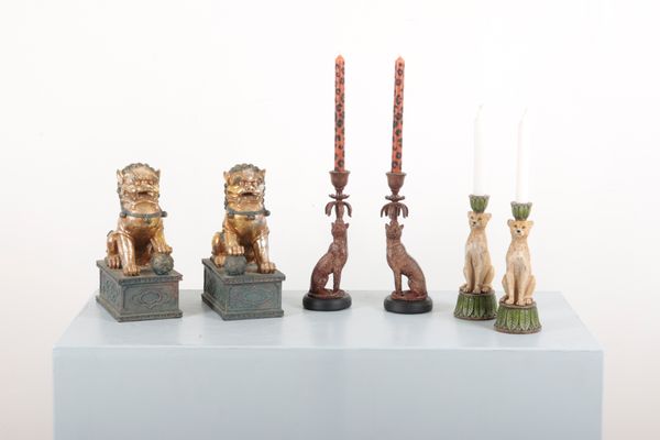 A PAIR OF OAK POLYCHROME PAINTED SEATED CHEETAH CANDLESTICKS