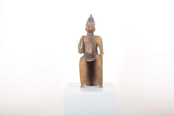 AN AFRICAN CARVED WOOD AND POLYCHROME-PAINTED FIGURE