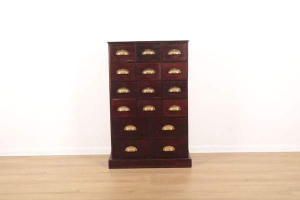 A STAINED PINE CHEST IN THE STYLE OF A FITTING FOR A CHEMIST SHOP