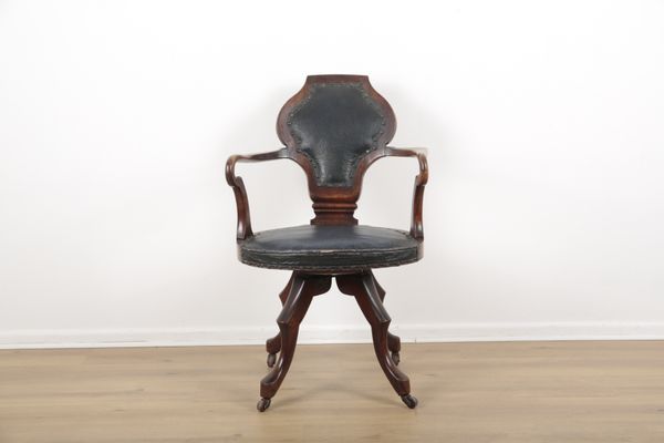 A LATE VICTORIAN SWIVEL ARMCHAIR