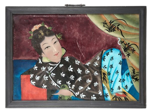 A CHINESE REVERSE PAINTED MIRROR OF A RECLINING LADY