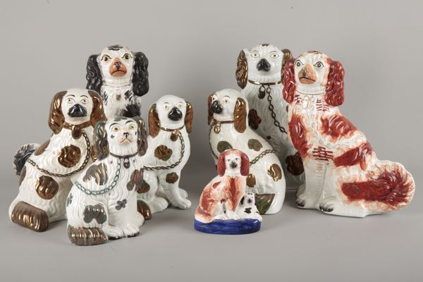 A PAIR OF 19TH CENTURY STAFFORDSHIRE POTTERY SPANIELS