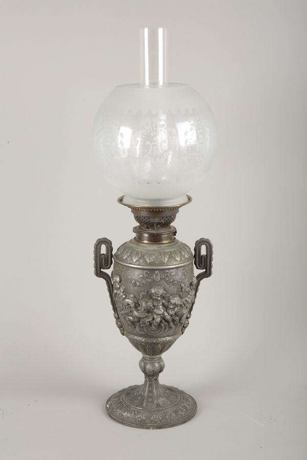 A VICTORIAN PEWTER OIL LAMP IN ROCOCO STYLE BY THE 'CANDLE COMPANY... NEW BOND STREET'