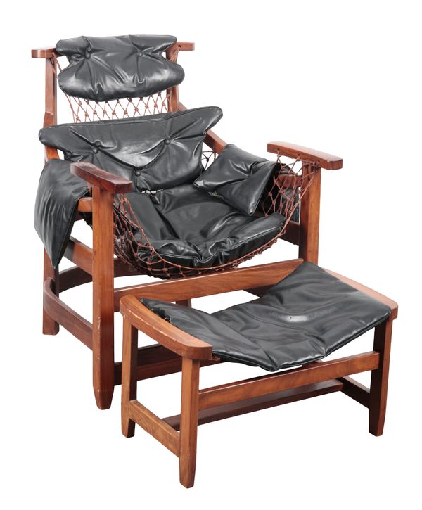 A ROSEWOOD 'JANGADA' LOUNGE CHAIR AND FOOTSTOOL IN THE STYLE OF JEAN GILLON (1919-2007)
