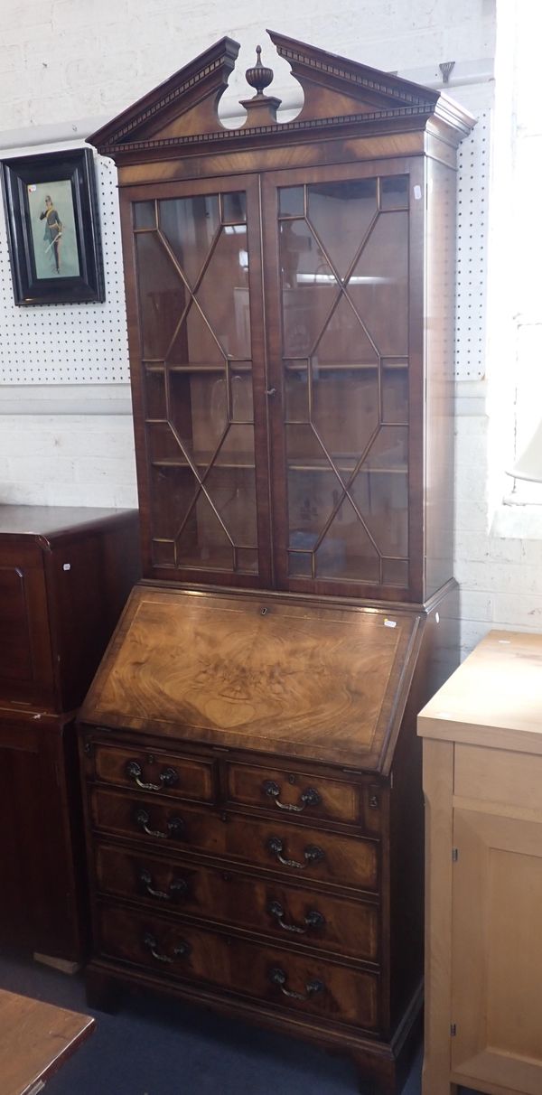 A REPRODUCTION FIGURED MAHOGANY BUREAU BOOKCASE