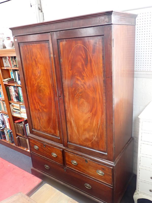 A 19th CENTURY FIGURED MAHOGANY LINEN PRESS