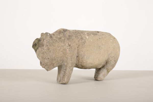 A COMPOSITE CARVED STANDING ANIMAL