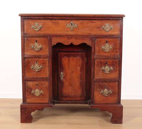 A GEORGE III MAHOGANY AND SATINWOOD CROSSBANDED KNEEHOLE DESK