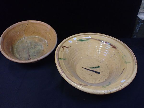 A LARGE YELLOW GLAZED EARTHENWARE DAIRY BOWL