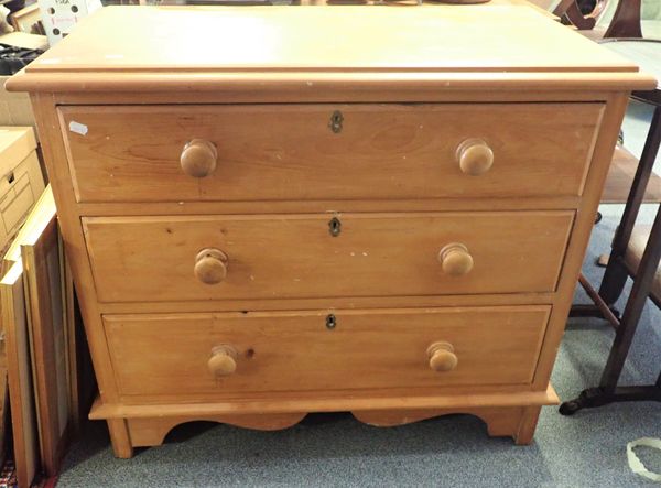 A SMALL STRIPPED PINE CHEST OF THREE DRAWERS