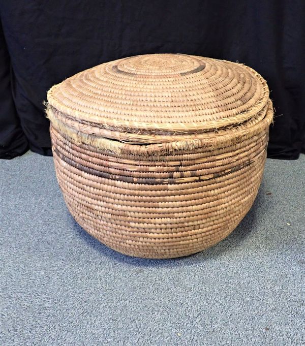 A COILED RUSH CIRCULAR LIDDED LAUNDRY BASKET