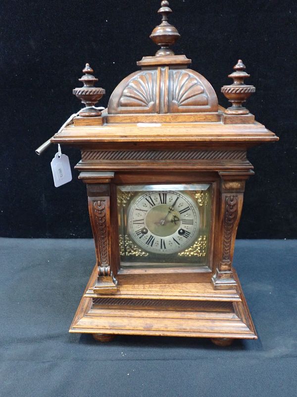 A GERMAN WALNUT CASED MANTEL CLOCK