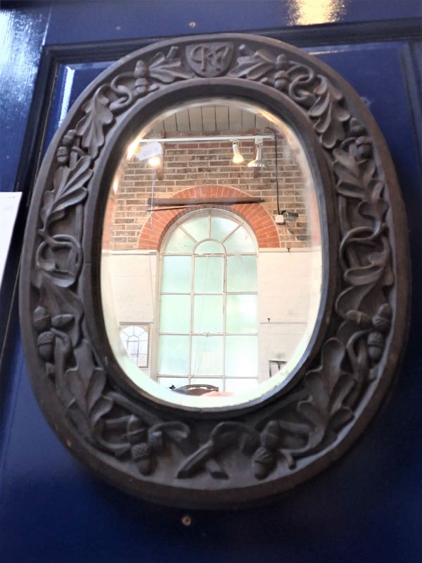 A 20TH CENTURY CARVED OAK MIRROR, REPUTEDLY THE WORK OF ITALIAN P.O.W.s