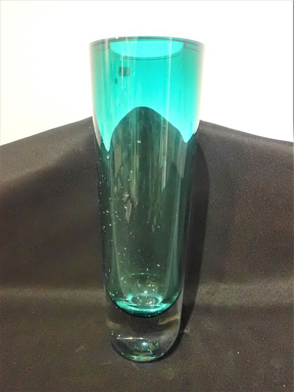 A TALL HEAVY GREEN GLASS CYLINDRICAL VASE