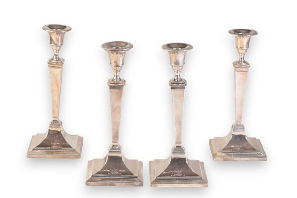 A SET OF FOUR GEORGE III SILVER PILLAR CANDLESTICKS