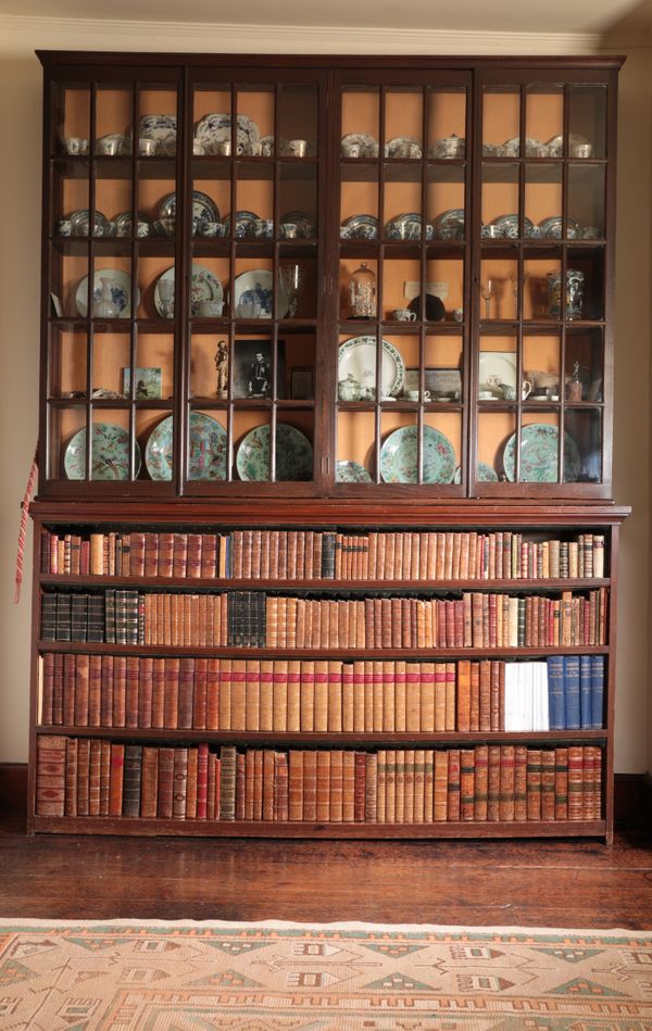 AN OAK AND STAINED WOOD LIBRARY BOOKCASE