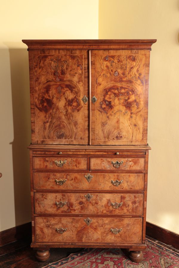 A QUEEN ANNE WALNUT VENEERED CABINET ON CHEST