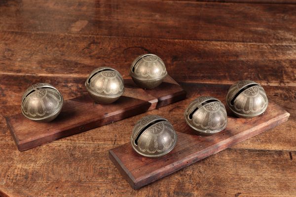 A SET OF SIX METAL RUMBLER BELLS