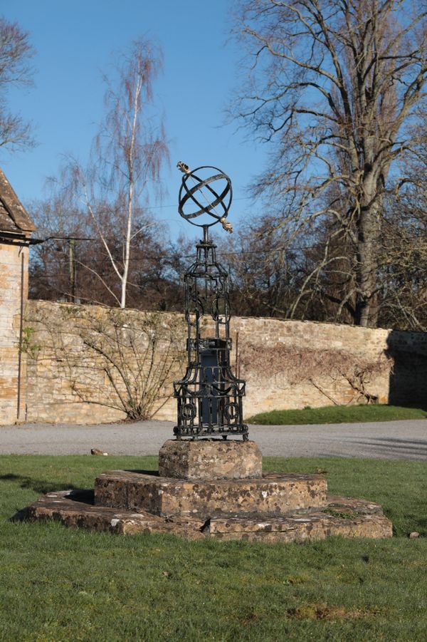 A NEO-CLASSICAL BLACK PAINTED IRON AND PARCEL-GILT ARMILLARY SPHERE