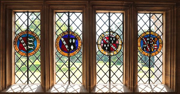 A SET OF FIVE STAINED GLASS HERALDIC ROUNDELS