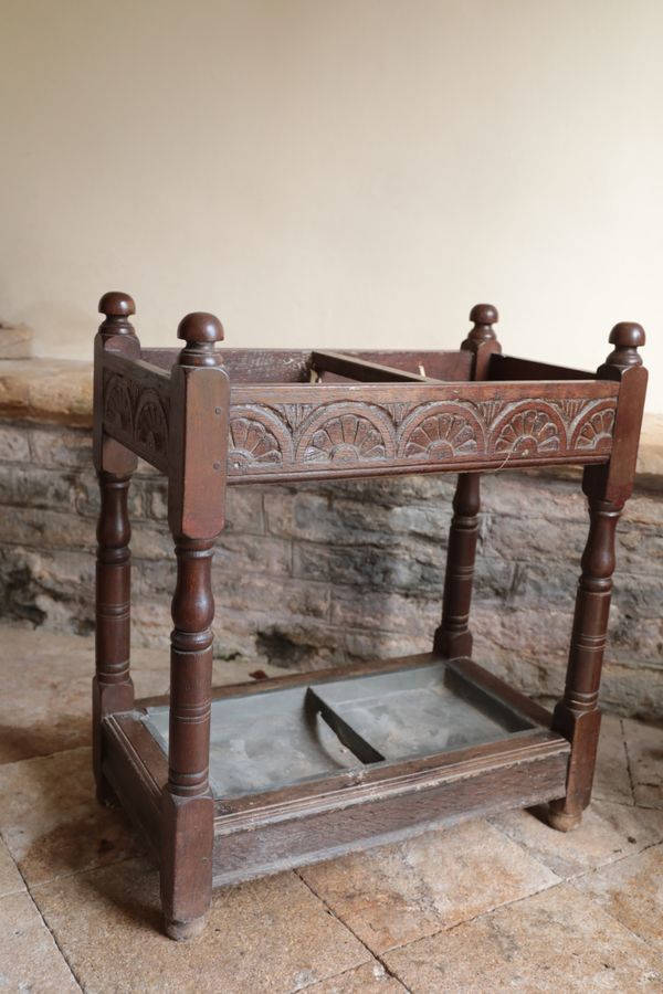 AN EDWARDIAN OAK STICK STAND