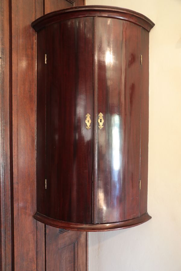 A GEORGE II WALNUT HANGING CORNER CUPBOARD