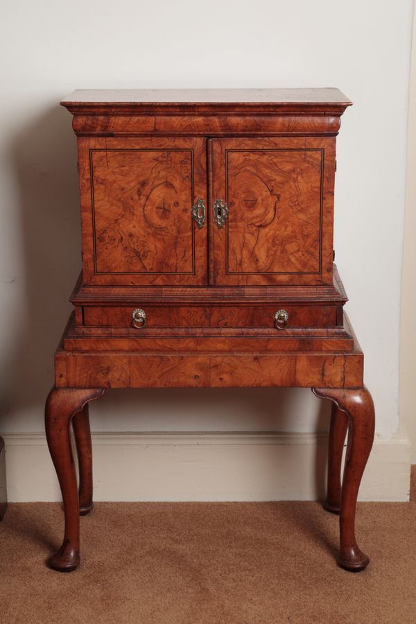 A RARE GEORGE I ASH-VENEERED MINIATURE CABINET ON STAND