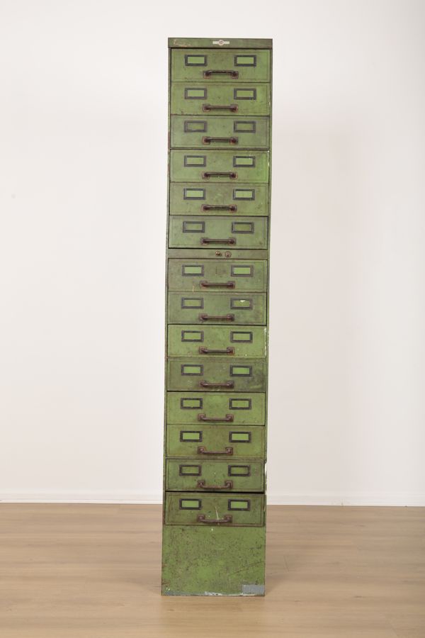 A GREEN PAINTED METAL FILING CABINET WITH WEIGHTED PLINTH