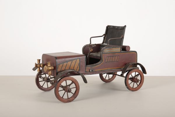 A METAL AND PAINTED WOODEN MODEL OF A VETERAN CAR